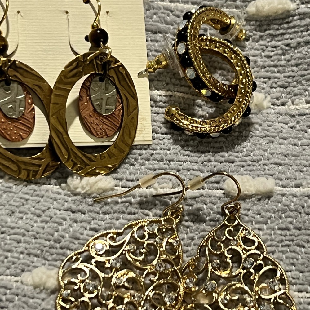 Three pierced earrings. All gold tone and mixed metals.